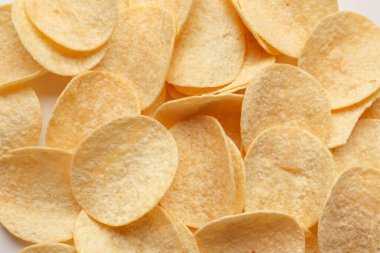 Delicious potato chips as background