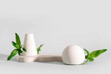 Green bamboo stems and plaster podiums on white background