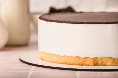 Tasty birds milk cake on color tile table, closeup