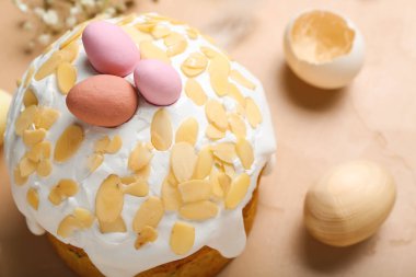 Easter cake and painted eggs on beige grunge background