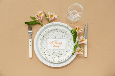 Anneler Günü kutlaması için arkaplandaki alstromerya çiçekleriyle güzel bir sofra.