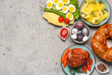 Tasty dishes and painted eggs for Easter dinner on grunge background