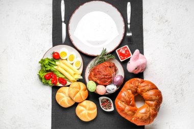 Easter table setting with tasty dishes on light background