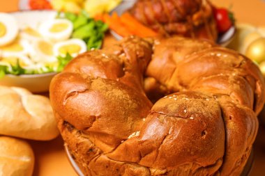Tasty Easter wreath bread and dishes for dinner, closeup