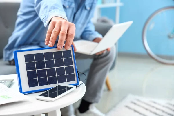 Young Man Charging Mobile Phone Portable Solar Panel Table Closeup — Stock Photo, Image