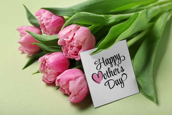 Greeting card with text HAPPY MOTHER\'S DAY and beautiful tulip flowers on green background