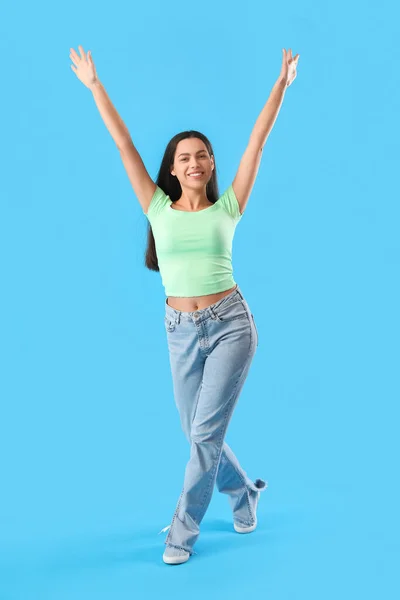 Happy young woman on blue background