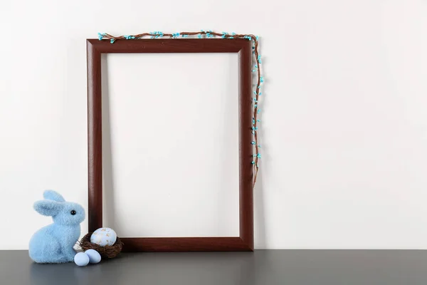 Blank frame, Easter eggs and bunny on white background