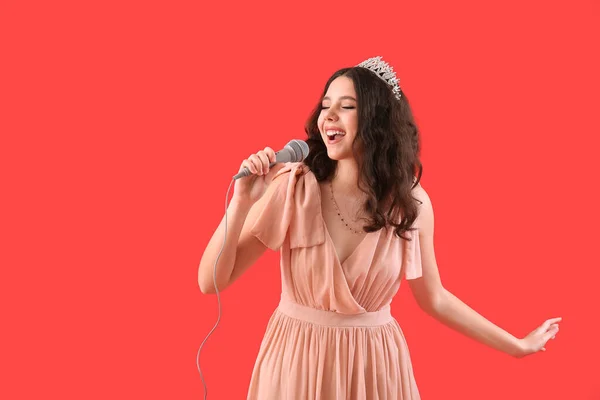 Tiener Meisje Tiara Prom Jurk Met Microfoon Zingen Rode Achtergrond — Stockfoto