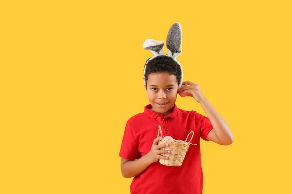 African American Little Boy Bunny Ears Basket Easter Eggs Yellow — Zdjęcie stockowe