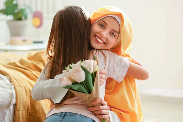 Happy Muslim Woman Tulips Hugging Her Little Daughter Home Mother — Stockfoto