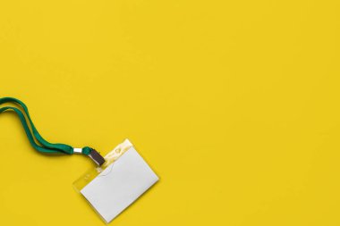 Blank badge with green lanyard on yellow background