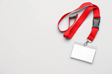 Blank badge with red lanyard on light background