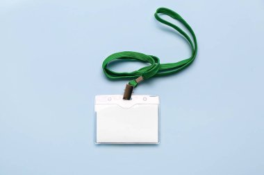 Blank badge with green lanyard on color background