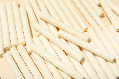 Delicious wafer rolls as background, closeup