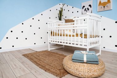 Interior of children's bedroom with crib and pictures