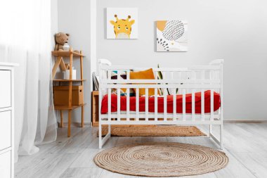 Interior of children's bedroom with crib and shelving unit