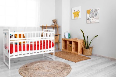 Interior of children's bedroom with crib and shelving unit