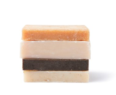 Stack of different soap bars isolated on white background