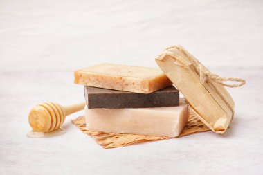 Stack of natural soap bars on light background