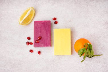 Natural soap bars and fruits on light background