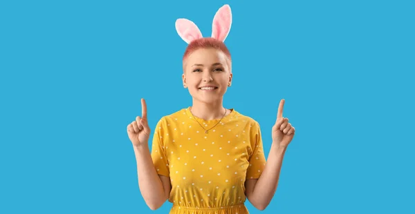 Young Woman Easter Bunny Ears Pointing Something Blue Background — Stok fotoğraf