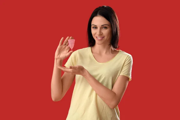 Young Woman Showing Menstrual Cup Red Background — Stock Photo, Image