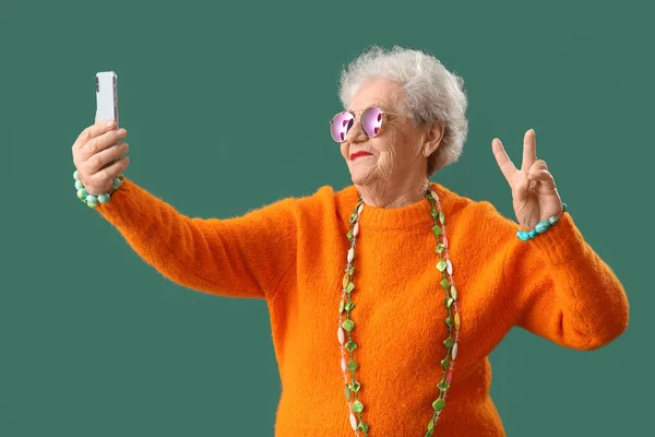 Senior Woman Bright Accessories Taking Selfie Green Background — 图库照片