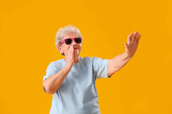Senior Woman Sunglasses Yellow Background — стоковое фото