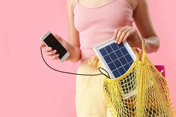 Woman Charging Mobile Phone Portable Solar Panel Pink Background Closeup — Stock Photo, Image