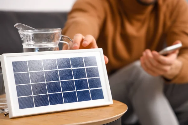 Young Man Mobile Phone Portable Solar Panel Home Closeup — Stock Photo, Image