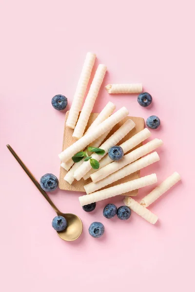 Board Delicious Wafer Rolls Blueberries Mint Pink Background — Stock Photo, Image