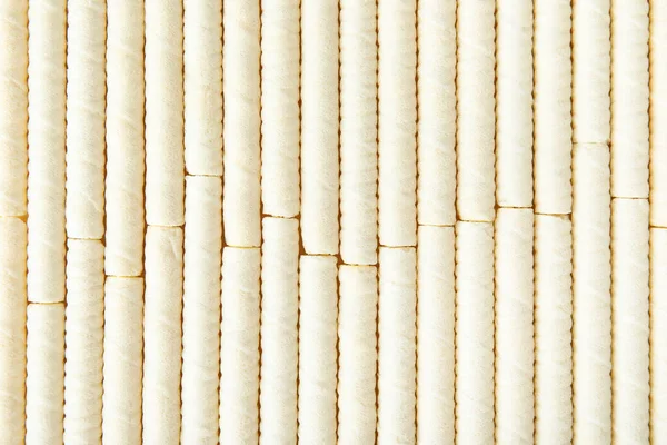 Delicious wafer rolls as background, closeup