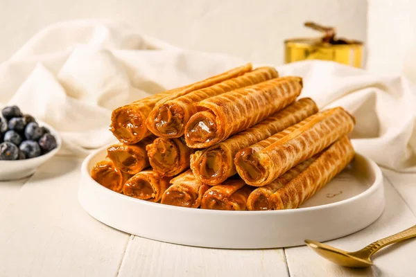 Plate Delicious Wafer Rolls Boiled Condensed Milk White Wooden Table — Stock Photo, Image