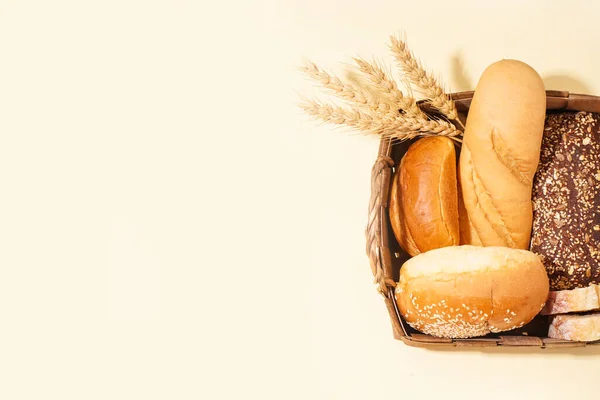 Basket Loaves Different Bread Wheat Ears Yellow Background — Fotografia de Stock