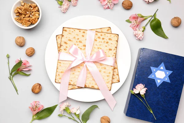 stock image Composition with Jewish flatbread matza for Passover, Torah, walnuts and alstroemeria flowers on light background