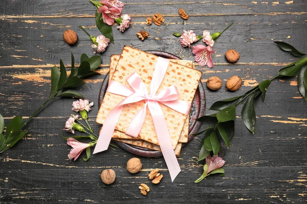 stock image Composition with Jewish flatbread matza for Passover, walnuts, flowers and plant branches on dark wooden background