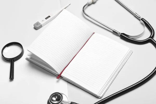 Blank Notebook Stethoscope Thermometer Magnifier White Grey Background World Health — Stok fotoğraf