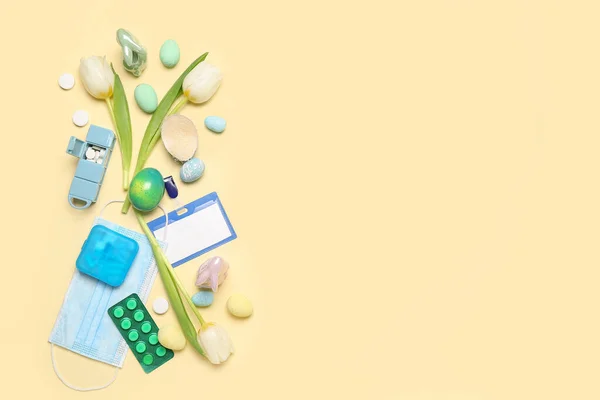 Blank badge with Easter eggs, pills and tulips on beige background. World Health Day