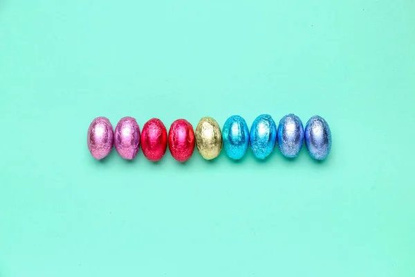 Row Chocolate Easter Eggs Foil Color Background — Stock Photo, Image