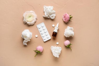 Nasal drops with pills, flowers and tissues on beige background. Seasonal allergy concept