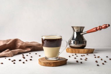 Glass cup of delicious Cafe Bombon on light table