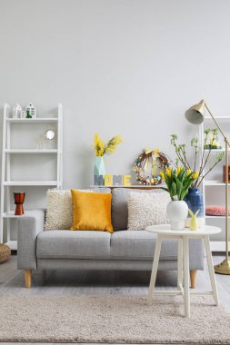 Interior of living room with Easter wreath, decor and sofa