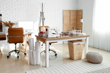 Interior of atelier with workplace and sewing supplies