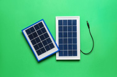 Portable solar panels on green background