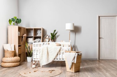 Interior of children's bedroom with baby crib and shelving unit