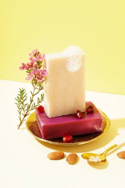 Composition with soap bars and natural ingredients on color background