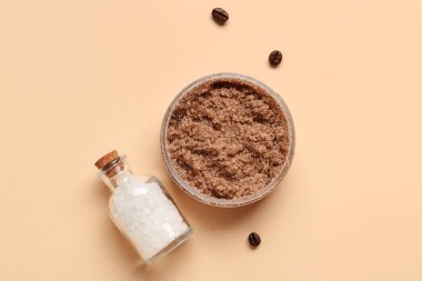 Jar with body scrub and bottle of sea salt on color background