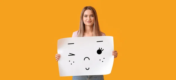 Happy Young Woman Holding Paper Cute Drawn Emoticon Yellow Background —  Fotos de Stock