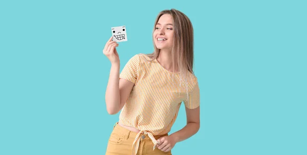 Happy Young Woman Holding Small Paper Smiling Emoticon Light Blue — Stock fotografie